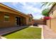 A quaint backyard featuring artificial turf and a gas firepit with an outdoor seating area at 1202 E Binner Dr, Chandler, AZ 85225