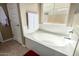 Soaking tub is surrounded by a large window, white tile and a nearby towel rack at 1202 E Binner Dr, Chandler, AZ 85225