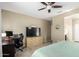 A well-lit bedroom offers a serene space with a large TV, desk, and a connecting bathroom at 1202 E Binner Dr, Chandler, AZ 85225
