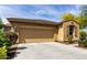 Exterior shot showcasing the two-car garage, neutral colors, and manicured landscaping against a blue sky at 1202 E Binner Dr, Chandler, AZ 85225