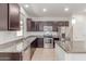 Gourmet kitchen featuring stainless appliances, granite countertops, and tile flooring at 1202 E Binner Dr, Chandler, AZ 85225