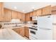 Well-lit kitchen with ample counter space, modern appliances, and wood cabinetry at 12221 W Bell Rd # 362, Surprise, AZ 85378
