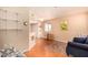 Open-concept living area with shelving and eat-in kitchen showcases a comfortable sofa at 12221 W Bell Rd # 362, Surprise, AZ 85378