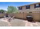 Private backyard with a gravel landscape, brick patio, and a grill, perfect for outdoor entertaining at 1265 S Aaron -- # 277, Mesa, AZ 85209
