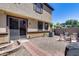 Landscaped backyard with sliding glass doors, a gravel yard, and a brick patio, perfect for relaxing at 1265 S Aaron -- # 277, Mesa, AZ 85209