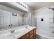 Bright bathroom featuring a double sink vanity, a large mirror, and a shower-tub combination at 1265 S Aaron -- # 277, Mesa, AZ 85209