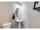 Cozy powder room with pedestal sink, oval mirror, and modern fixtures for guests' convenience at 1265 S Aaron -- # 277, Mesa, AZ 85209