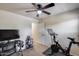 Bedroom featuring a fan, desk, and stationary bike at 1265 S Aaron -- # 277, Mesa, AZ 85209
