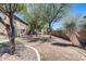 Scenic community greenspace featuring mature trees, gravel landscaping, and proximity to residential buildings at 1265 S Aaron -- # 277, Mesa, AZ 85209