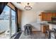 Cozy dining area with modern light fixture and slider door leading to outdoor patio at 1265 S Aaron -- # 277, Mesa, AZ 85209