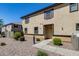 Two-story stucco home with brown trim, shutters and desert landscaping at 1265 S Aaron -- # 277, Mesa, AZ 85209