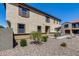 Two-story stucco home with brown trim, shutters and desert landscaping at 1265 S Aaron -- # 277, Mesa, AZ 85209