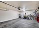 Spacious garage with overhead storage and automatic door, offering ample room for vehicles and storage at 1265 S Aaron -- # 277, Mesa, AZ 85209