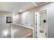 Bright hallway featuring multiple doors, including access to a full bathroom at 1265 S Aaron -- # 277, Mesa, AZ 85209
