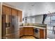 Well-lit kitchen featuring stainless steel appliances, tiled floors, and a convenient dishwasher at 1265 S Aaron -- # 277, Mesa, AZ 85209