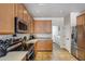 Bright kitchen boasting stainless steel appliances and durable tile flooring at 1265 S Aaron -- # 277, Mesa, AZ 85209