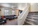 Inviting living room with plush seating, modern ceiling fan, and staircase access to upper level at 1265 S Aaron -- # 277, Mesa, AZ 85209