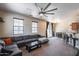 Spacious living room with large sectional, ceiling fan, and access to outdoor patio at 1265 S Aaron -- # 277, Mesa, AZ 85209