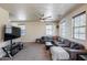 Large living room with neutral paint, carpeting, ceiling fan and a large sectional at 1265 S Aaron -- # 277, Mesa, AZ 85209