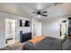 Spacious main bedroom featuring a ceiling fan, TV, and convenient access to a walk-in closet and attached bathroom at 1265 S Aaron -- # 277, Mesa, AZ 85209