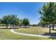 Expansive green park with mature trees, walking paths, and recreational areas for community enjoyment at 1265 S Aaron -- # 277, Mesa, AZ 85209