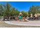 Community playground with shade trees and seating area at 1265 S Aaron -- # 277, Mesa, AZ 85209
