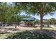 Community playground with a shade structure, surrounded by lush trees and picnic areas at 1265 S Aaron -- # 277, Mesa, AZ 85209
