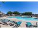 Community pool and lounging area under a bright blue sky at 1265 S Aaron -- # 277, Mesa, AZ 85209