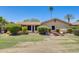 A backyard with well-manicured lawn, mature trees, and an outdoor seating area at 1289 Leisure World --, Mesa, AZ 85206