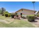 The backyard has a small outdoor seating area surrounded by manicured greenery and trees at 1289 Leisure World --, Mesa, AZ 85206