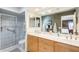Bathroom featuring a tiled shower, dual sinks, and a large mirror at 1289 Leisure World --, Mesa, AZ 85206