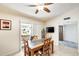 Charming dining area with a rustic table set, opening to a patio and hallway at 1289 Leisure World --, Mesa, AZ 85206