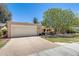 Single-level home boasting a two-car garage, landscaped front yard, and covered front porch at 1289 Leisure World --, Mesa, AZ 85206