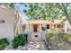 Charming front entrance with gate, flowerpots, and shaded seating area, creating a welcoming entry at 1289 Leisure World --, Mesa, AZ 85206