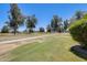 Expansive golf course with clear skies, verdant grass, and mature trees, creating a serene landscape at 1289 Leisure World --, Mesa, AZ 85206