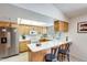 Bright kitchen with white countertops, wood cabinets, and a breakfast bar for casual dining at 1289 Leisure World --, Mesa, AZ 85206