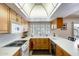 Bright kitchen featuring warm wood cabinetry, white countertops, and natural light from window at 1289 Leisure World --, Mesa, AZ 85206