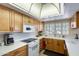 Charming kitchen featuring wood cabinets, modern appliances, and a bright, airy atmosphere at 1289 Leisure World --, Mesa, AZ 85206