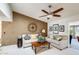 Bright living room showcasing a decorative wall, comfortable seating, and a ceiling fan at 1289 Leisure World --, Mesa, AZ 85206