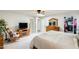 Bright main bedroom with a ceiling fan, closet, dresser, and comfortable rocking chair at 1289 Leisure World --, Mesa, AZ 85206