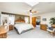 Light-filled main bedroom with a ceiling fan, comfortable bed, and access to an adjacent living area at 1289 Leisure World --, Mesa, AZ 85206