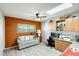 Bright office space with built-in cabinets, desk, and a comfortable seating area at 1289 Leisure World --, Mesa, AZ 85206