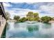 Scenic pond view featuring a water fountain surrounded by lush landscaping at 1289 Leisure World --, Mesa, AZ 85206