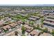Expansive aerial view of a residential community featuring well-maintained homes, lush landscaping, and community pools at 1360 S Camellia Ct, Chandler, AZ 85286