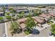 Aerial shot of home in a beautiful neighborhood with mature trees and a well-manicured lawn at 1360 S Camellia Ct, Chandler, AZ 85286