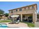 Backyard patio with outdoor seating and umbrella, overlooking a refreshing pool at 1360 S Camellia Ct, Chandler, AZ 85286