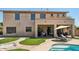 Backyard patio with outdoor seating and umbrella, overlooking a refreshing pool at 1360 S Camellia Ct, Chandler, AZ 85286