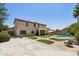 Backyard view of a two-story home featuring a lawn, covered patio, and swimming pool at 1360 S Camellia Ct, Chandler, AZ 85286