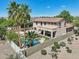 Aerial view of the backyard with a sparkling pool, lush greenery, and a covered patio, ideal for outdoor living at 1360 S Camellia Ct, Chandler, AZ 85286