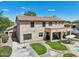 A two-story home with a covered patio and outdoor seating, complemented by a lush lawn at 1360 S Camellia Ct, Chandler, AZ 85286